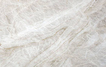 A honed Taj Mahal quartzite sample, cream with soft grey veining.